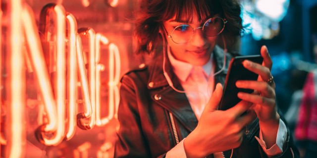 A young woman shops e-commerce on her mobile cell phone
